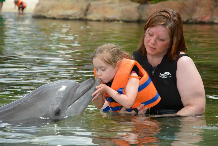 Emma kissing the Dolphin with me