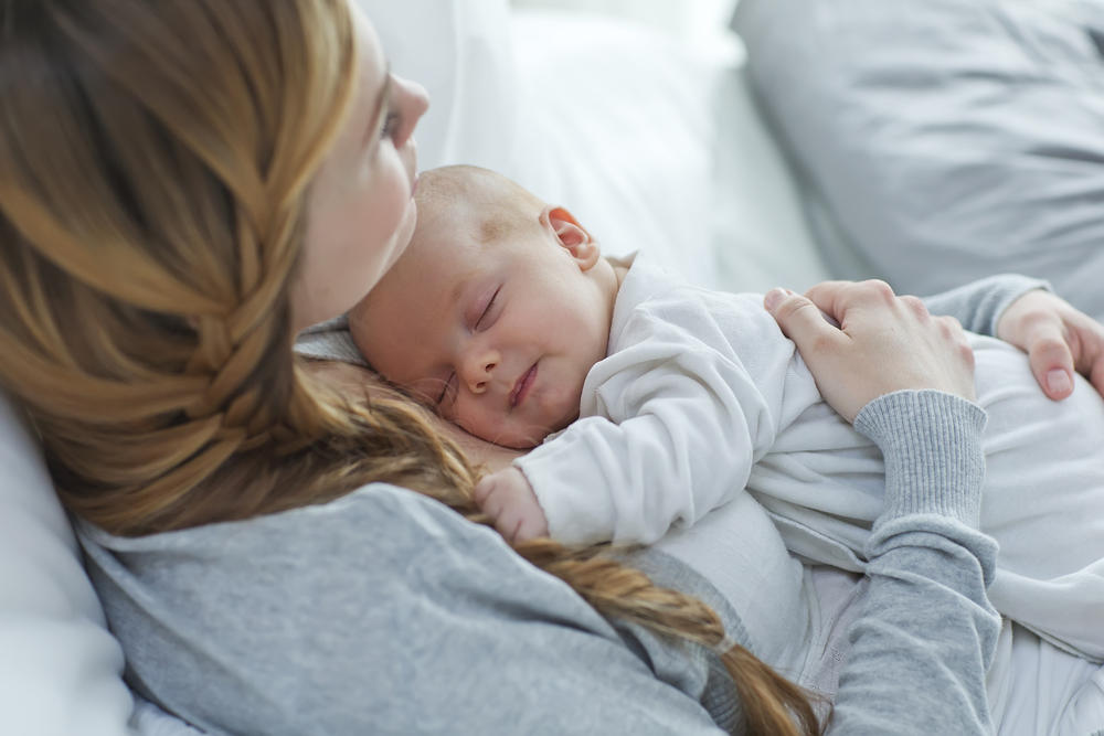 newborn baby sleeping with mom